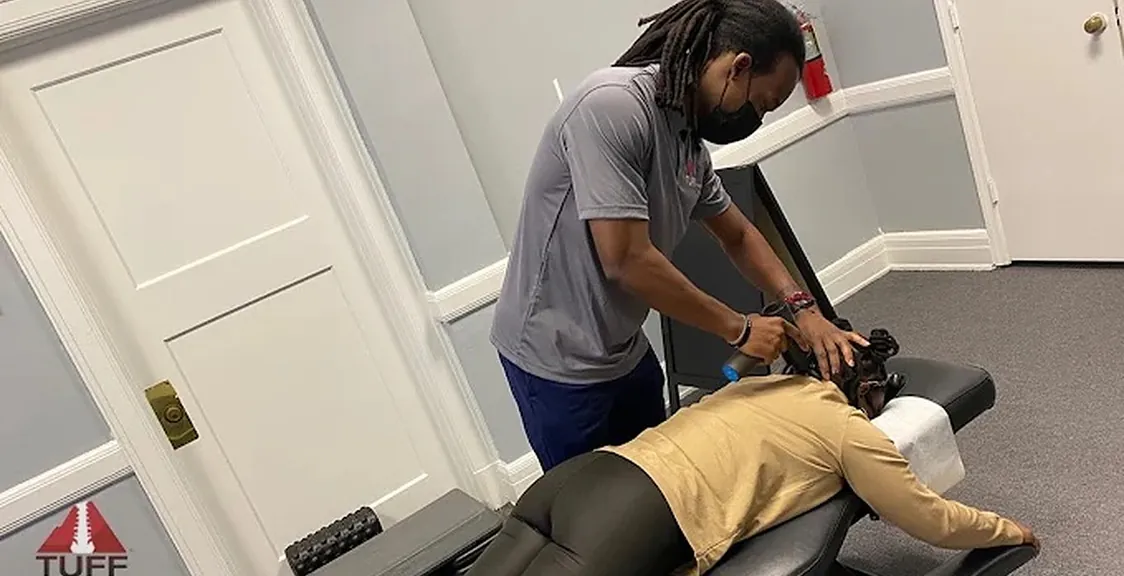 Dr. Lewis treating a patient's neck