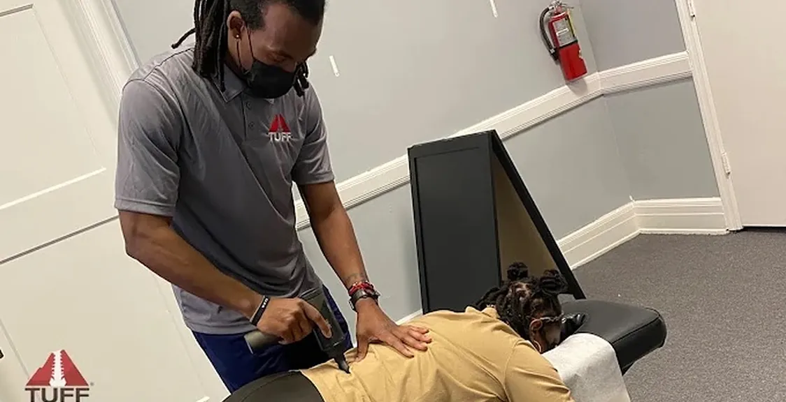 Dr. Lewis performing hands-on back treatment